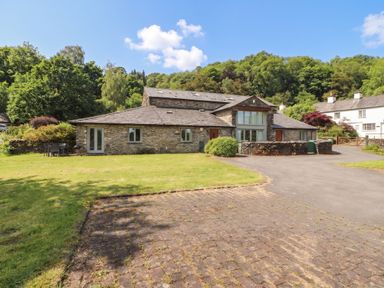 A house with a garden and pathway at Winster Fields Cartmel Fell near Windermere