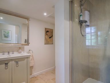 A bathroom with a sink and shower at Church Farmhouse in Winsham