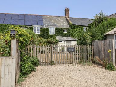 An entrance with a fence and welcome sign at Church Farmhouse in Winsham