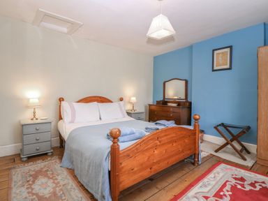 A bedroom with a bed and bedside table at The Lock House in Gloucester