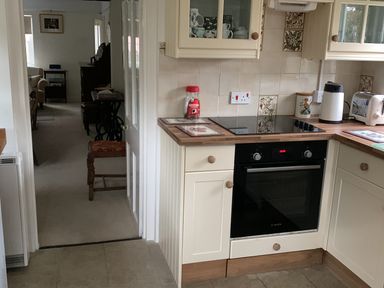 A kitchen with an oven and cabinets at 28 Oxborough