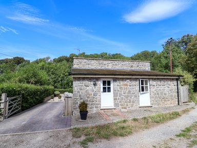 A stone building with doors and windows at The Lambing Shed in Dyserth near Prestatyn