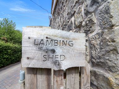 A wooden sign stating Lambing Shed at The Lambing Shed Dyserth near Prestatyn