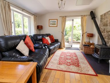 A living room with a sofa and coffee table at The Lambing Shed in Dyserth near Prestatyn