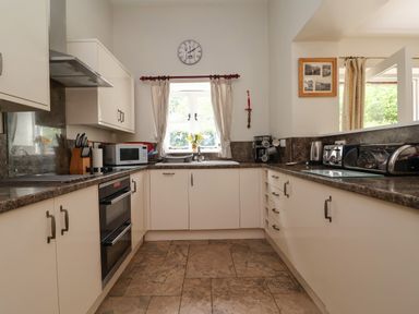 A kitchen with oven microwave and sink at The Lambing Shed near Dyserth