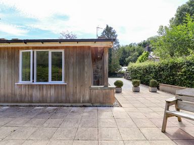 An outdoor area with a wooden wall and potted plants at The Lambing Shed Dyserth near Prestatyn