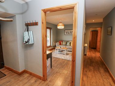 A living room with a sofa and coffee table at Lough Cluhir Cottage, Union Hall, County Cork