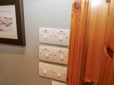 A switch panel for immersion, jacuzzi bath, water pump, and towel rail at Lough Cluhir Cottage in Union Hall, County Cork