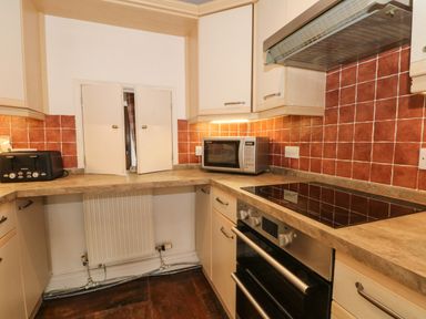 A kitchen with a microwave toaster electric stove oven under cabinets at Saddleback Barn Newton Reigny near Penrith