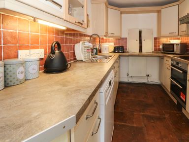 A kitchen with countertop appliances and cabinets at Saddleback Barn in Newton Reigny near Penrith