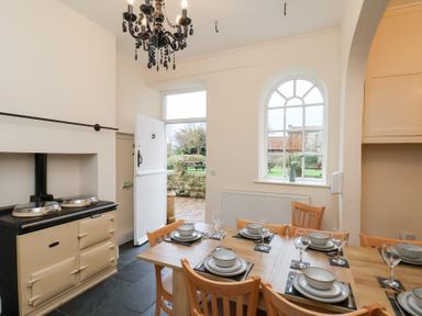 A kitchen with a dining table and chairs at The Lodge in Snainton near Scarborough