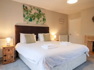 A bedroom with a bed and bedside tables at The Lodge in Snainton near Scarborough