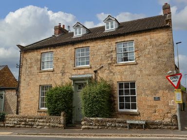 A house with stone exterior and windows at The Lodge Snainton near Scarborough