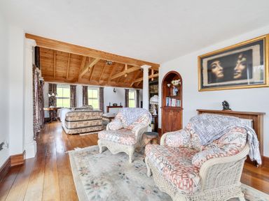 A living room with a sofa and armchairs at Chapel Green in Polgooth