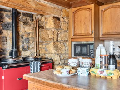 A kitchen with stove and countertop items at Chapel Green in Polgooth