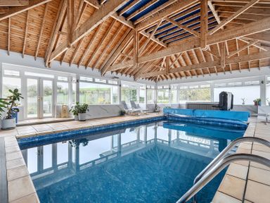 An indoor pool area with a hot tub at Chapel Green in Polgooth