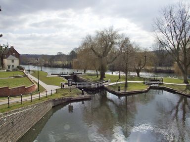 A lock on a river with pathways and trees beside water at Rosewaters Cottage in Astley Burf near Stourport-on-Severn
