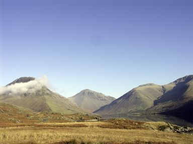 A landscape with mountains and a lake under a clear sky at William Court Cottage in Irton Hall near Wastwater