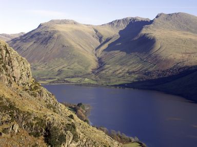 A lake surrounded by hills and rocky terrain at William Court Cottage Irton Hall near Wastwater