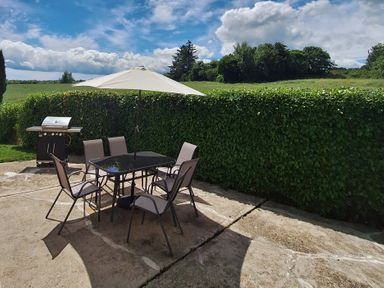 A patio with a table and chairs at 19 River Glen, Curracloe, County Wexford