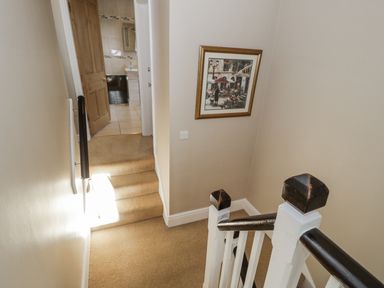 A staircase and a door leading to a bathroom at Tyddyn Goronwy in Talybont