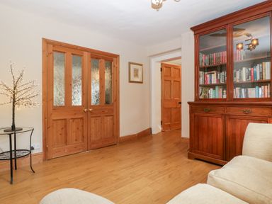 A snug with wooden doors and bookshelf at The Croft Vowchurch near Peterchurch