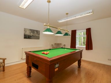 A games room with a pool table and a window at The Croft in Vowchurch near Peterchurch