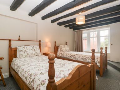 A bedroom with two single beds and a window at The Croft in Vowchurch near Peterchurch