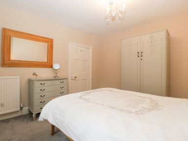 A bedroom with a bed and wardrobe at The Croft in Vowchurch near Peterchurch