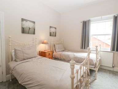 A bedroom with two beds and a bedside table at The Croft in Vowchurch near Peterchurch