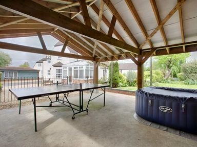 A covered outdoor area with a ping pong table and an inflatable hot tub at Ingleside Adsett Royal Forest of Dean