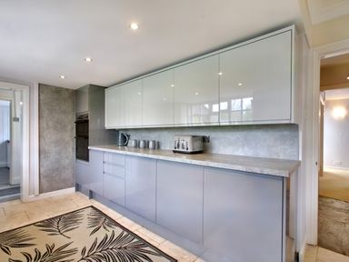 A kitchen with grey cabinets, a countertop, a toaster, a kettle, and three mugs at Ingleside in Adsett Royal Forest of Dean