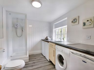 A utility room with a washing machine dishwasher shower and sink at Ingleside in Adsett Royal Forest of Dean