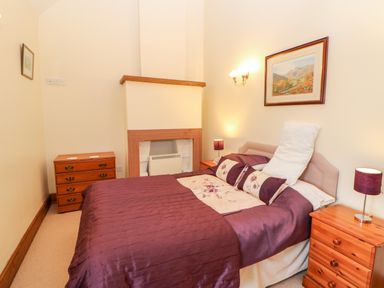 A bedroom with a double bed and two bedside tables with lamps at The Dairy in Milton near Brampton