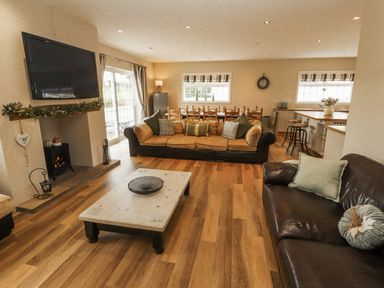A living room with a sofa and coffee table at White Gables in Great Clifton near Cockermouth