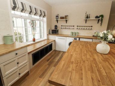 A kitchen with cabinets and appliances at White Gables Great Clifton near Cockermouth
