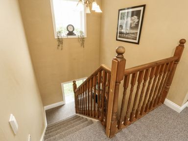 A staircase with a clock and picture frame at White Gables in Great Clifton near Cockermouth