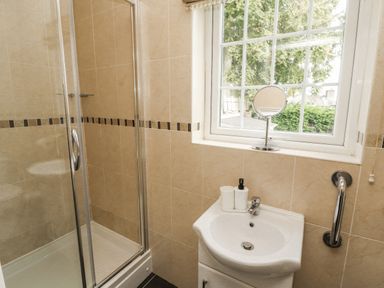 A bathroom with a shower and sink at White Gables in Great Clifton near Cockermouth