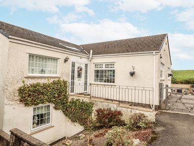 A house with a front door and windows at White Gables Great Clifton near Cockermouth