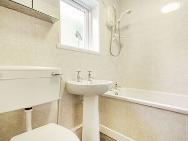 A bathroom with a toilet sink bathtub and shower at Penlan in Beddgelert