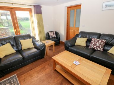 A living room with two sofas and a coffee table at Bwthyn Trecoed St. Clears near Carmarthen