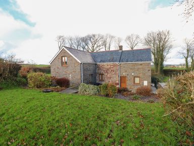 A house with a garden and trees at Bwthyn Trecoed in St. Clears near Carmarthen