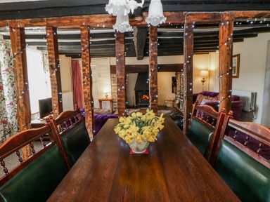 A dining room with a table and chairs at Penlone Cottage Rhayader