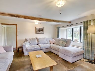 A living room with sofas coffee table window and floor lamp at The Birches in Hay-on-Wye