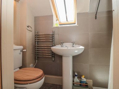 A bathroom with a toilet and wash basin at The Lodge Farm Barn Deepdean near Ross-on-Wye