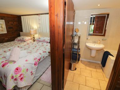 A bedroom with a bed and a bathroom area at Severn Bank Lodge Astley Burf near Stourport-on-Severn
