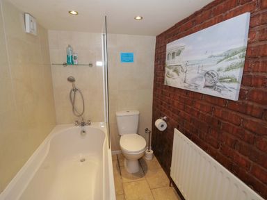 A bathroom with a bathtub and toilet at Severn Bank Lodge in Astley Burf near Stourport-on-Severn