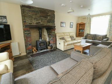 A living room with a fireplace and sofas at Halford Hill Llanberis