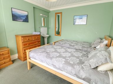 A bedroom with two beds and a dresser at Halford Hill in Llanberis