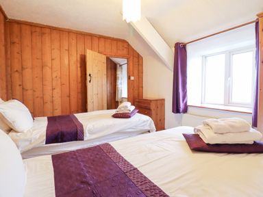 A bedroom with two beds and a window at Bryn Re Trawsfynydd near Llan Ffestiniog and Dolgellau
